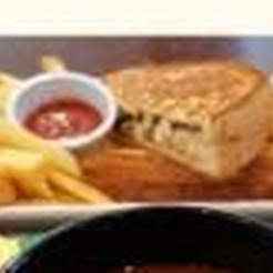 A toasted sandwich with chips and a bowl of soup, from Aon Scéal? Café's own flyer